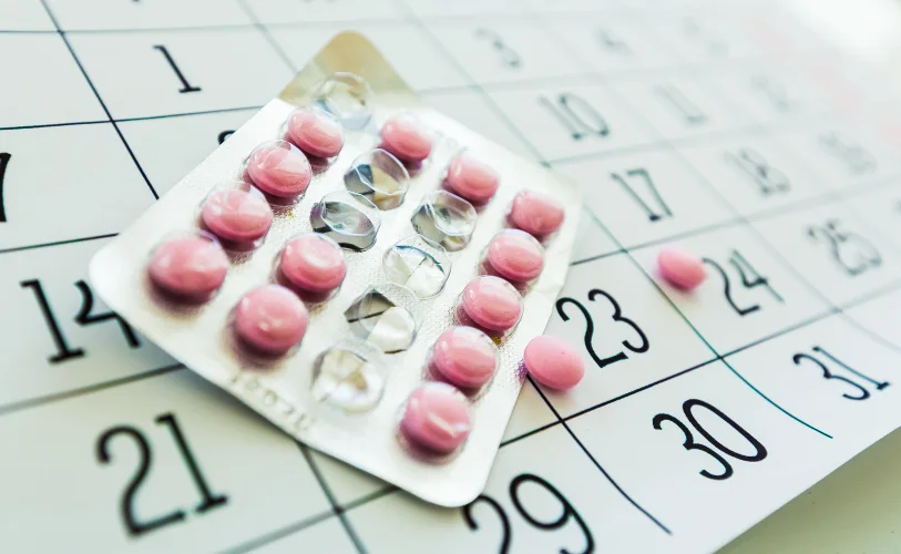 Medication blister packs placed on a calendar