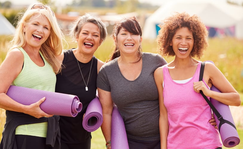 Women with yoga mats after exercising together
